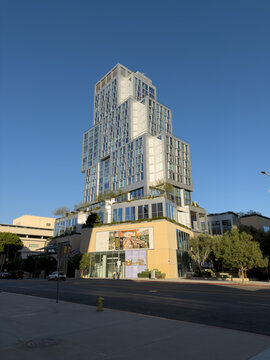 LOS ANGELES, CA, OCT 1, 2025: Contemporary stepped residential tower at The Grand in Downtown, with landscaped terraces rises above street-level retail displaying colorful dataland art signage