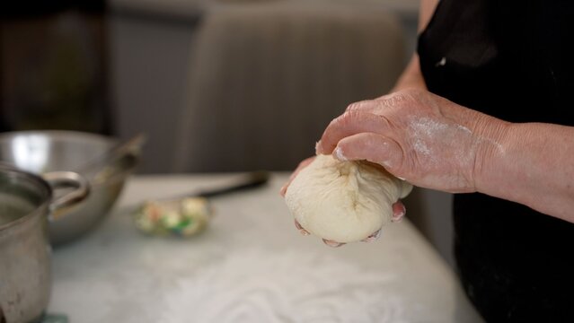 Woman's hands shaping homemade dough for baking