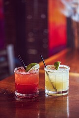 A strawberry and a classic margarita at a modern upscale bar 