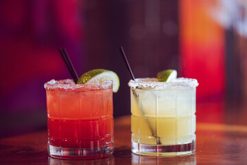 A strawberry and a classic margarita at a modern upscale bar 