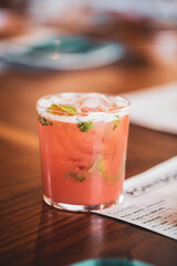 Tequila cocktail with fruit and mint served at an upscale food restaurant