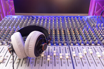 headphone on audio mixing console in studio. broadcasting, recording, music production concept