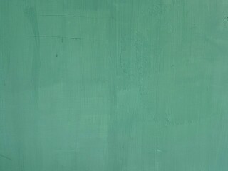 Obraz premium Smooth green painted wall surface featuring subtle brush textures and gentle tonal variations across the color