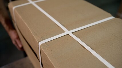 Person handling cardboard shipping package parcel box