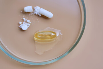 Pills medicine capsules and supplements in petri dish