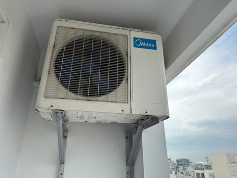 Midea Outdoor Air Conditioner Unit (HVAC Equipment) on a Building in Ho Chi Minh City, Vietnam, October 2025. 