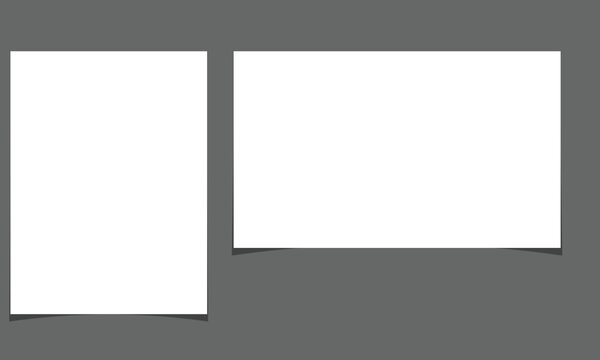 Two blank white rectangular papers on gray background