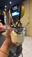 Hand holding a cup of frozen yoghurt