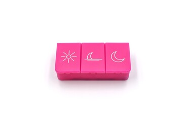 A pill organizer with compartments on a white background. A pillbox for daily medications for maintaining good health.