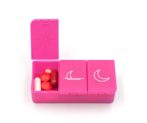 A pill organizer with compartments on a white background. A pillbox for daily medications for maintaining good health.