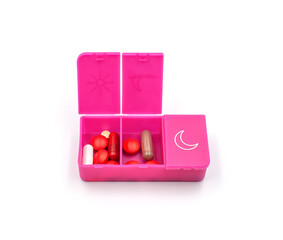 A pill organizer with compartments on a white background. A pillbox for daily medications for maintaining good health.