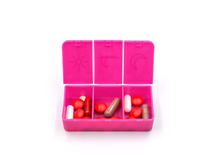 A pill organizer with compartments on a white background. A pillbox for daily medications for maintaining good health.