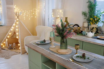Cozy Christmas kitchen interior with festive table setting and kids teepee lights