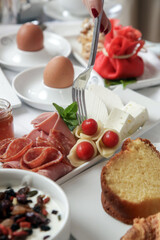 Young woman enjoying hotel breakfast with various choice of food