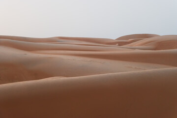 sand dunes in Wahiba (Sharqiya) Sands, which is a large desert in the east of Oman; Abstract photo for wallpaper