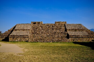Zapotec Stepped Pyramid Ruins in Grassy Plaza (Monte Alban, Oaxaca, Mexico)
