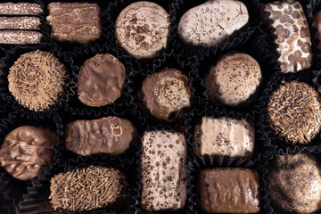 Various chocolate candies in the box closeup
