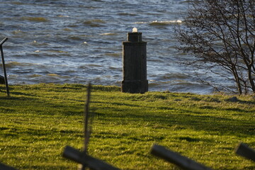 lighthouse on the shore of a lake