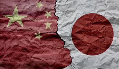 Chinese and Japanese flags on a cracked background. Political and economic conflict between China and Japan. Diplomatic conflict.