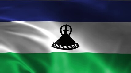 waving national flag of lesotho with traditional mokorotlo hat emblem on blue white green fabric texture