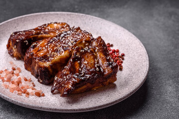 Grilled or bbq pork ribs with sauce, a food prepared for dinner. Grilled ribs