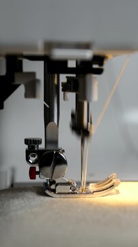 Side View of Sewing Machine Stitching with Light Thread. Viertical Video