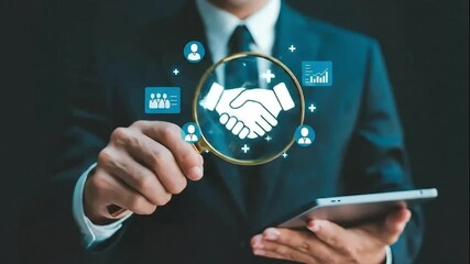 Digital Partnership: A business professional, in a dark suit, magnifying a handshake symbol, and tablet, symbolizing the power of collaboration and partnership in the digital age. - Powered by Adobe