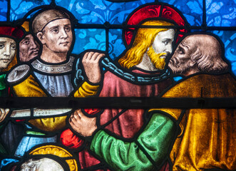 Stained glass (19th century) of Jesus receiving kiss of Judas.