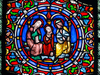 Stained glass (19th century) of the young Virgin Mary with her parents Saint Anne and Saint Joachim.