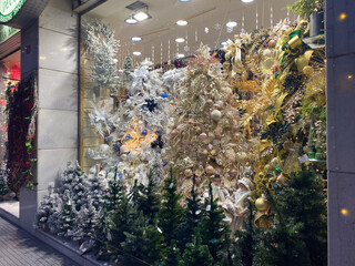Festive christmas window display with ornate decorations and glittering trees