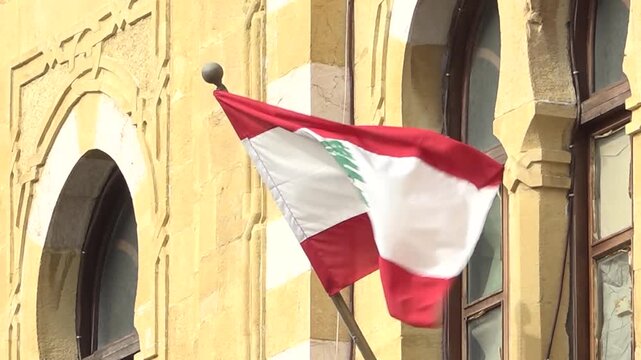 06-08-2025 shoting in Beirut, Lebanon,f lag is a horizontal triband of two red stripes enveloping a central white stripe. Centered on the white stripe is a green cedar of Lebanon tree.
