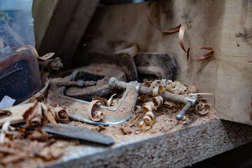 A cluttered workbench filled with woodworking tools and shavings illustrates a craftsman’s workspace, encapsulating creativity, productivity, and the essence of manual labor.