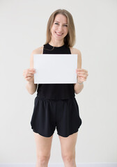 Smiling Woman Holding Blank White Sign for Your Message