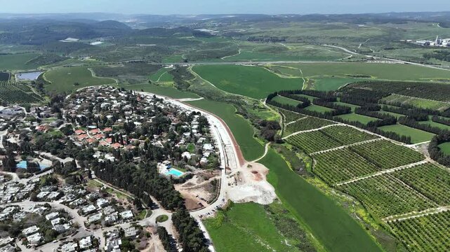 Aerial 4K footage of Ben Shemen Forest in central Israel, featuring the iconic &ldquo;Chinese House&rdquo; structure surrounded by dense Mediterranean woodland. The drone captures sweeping views of green pine tre
