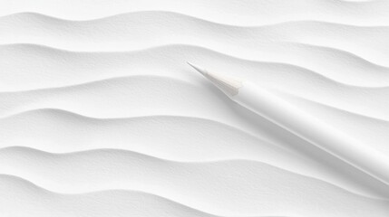 A white pencil with a sharpened tip rests on a white surface.