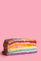Piece of rainbow cake, dessert background, copy space.