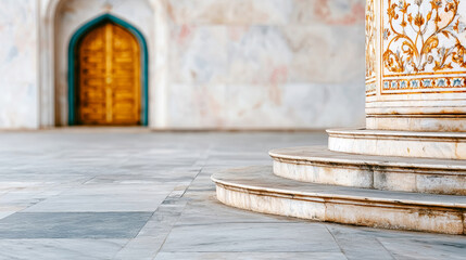Historical building displaying intricate marble craftsmanship, featuring a decorative column, curved steps, and a blurred arched doorway