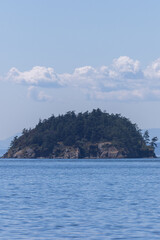 Tall Cloudscape Above Forested Coastal Island