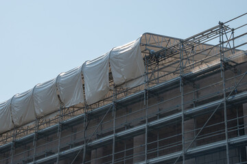 Scaffolding on the roof of a construction site to protect workers from the sun's rays and heat, Rome, Italy.