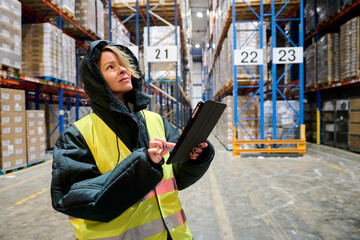 Woman worker managing logistics in cold chain warehouse