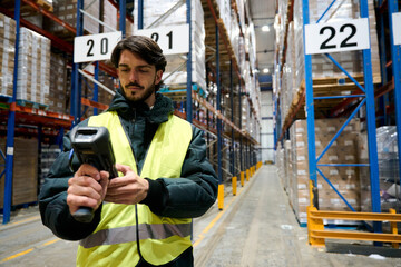 Worker scanning barcode in cold chain warehouse inventory