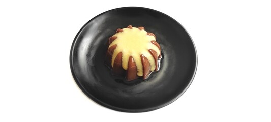 Chocolate Pudding with Creamy Vanilla Sauce  Custard on Black Plate Isolated on White Background. Food Stylish Photography