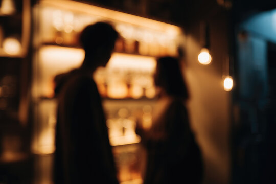 Blurred couple sharing cocktail in dimly lit bar warm lighting romantic atmosphere defocused background nightlife cozy setting soft focus evening mood social interaction