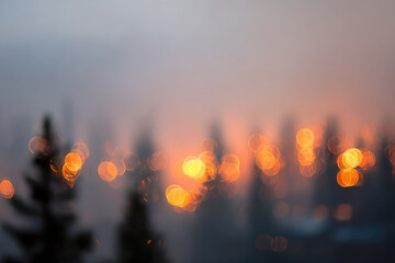 Blurred trees silhouetted in wildfire haze with glowing orange bokeh lights create dramatic, moody forest scene, evoking sense of urgency and environmental concern