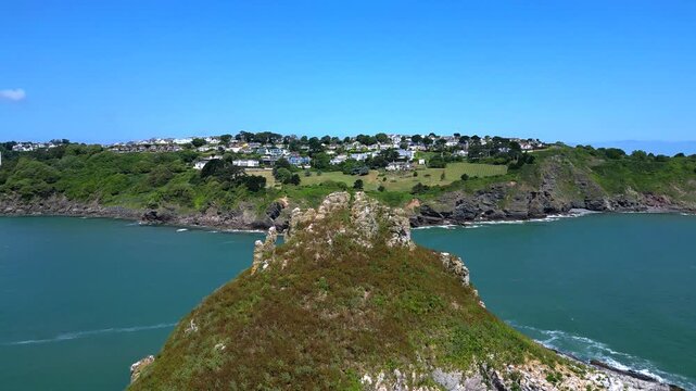 Torbay, South Devon, England: DRONE VIEWS: Thatcher Rock, which is an island rock located just off the mainland. Torbay is a popular UK holiday destination and retirement area (Clip 3 of 6).