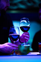 Bartender holding  a wine glasses