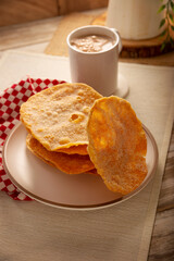 Buñuelos de rodilla. Traditional food at Christmas and winter holidays in Mexico, these are fried dough flour sprinkled with sugar or covered in a syrup made with piloncillo, cinnamon, and guava.