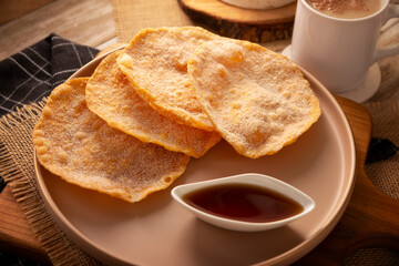 Buñuelos de rodilla. Traditional food at Christmas and winter holidays in Mexico, these are fried dough flour sprinkled with sugar or covered in a syrup made with piloncillo, cinnamon, and guava.