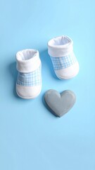 Newborn Baby Boy Booties and Grey Heart Flat Lay. Cute Gingham Shoes on Pastel Blue Background for Gender Reveal.