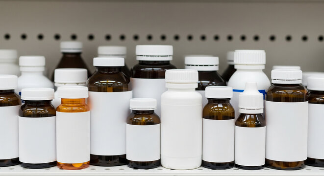 Assorted Medicine and Pharmaceutical Bottles Lined Up on a Pharmacy Shelf

A close-up view captures a variety of pharmaceutical and medicine bottles lined up neatly on a white shelf in a pharmacy or d